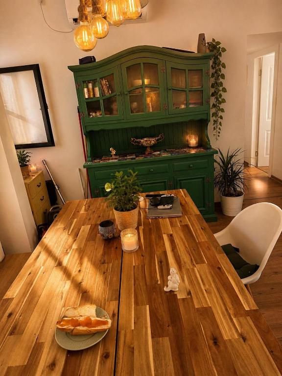 a wooden table in a room with a green cabinet at Cozy flat near park in Netanya