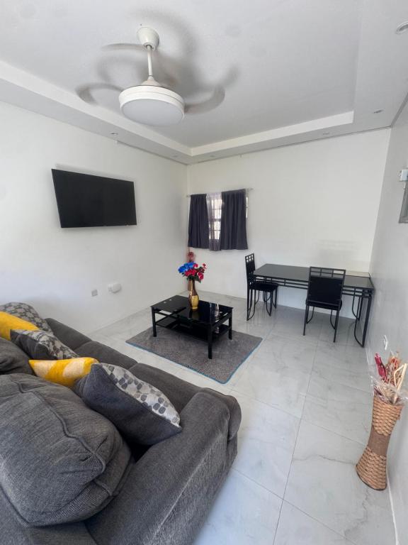 a living room with a couch and a table at Faith moves mountains in Ocho Rios