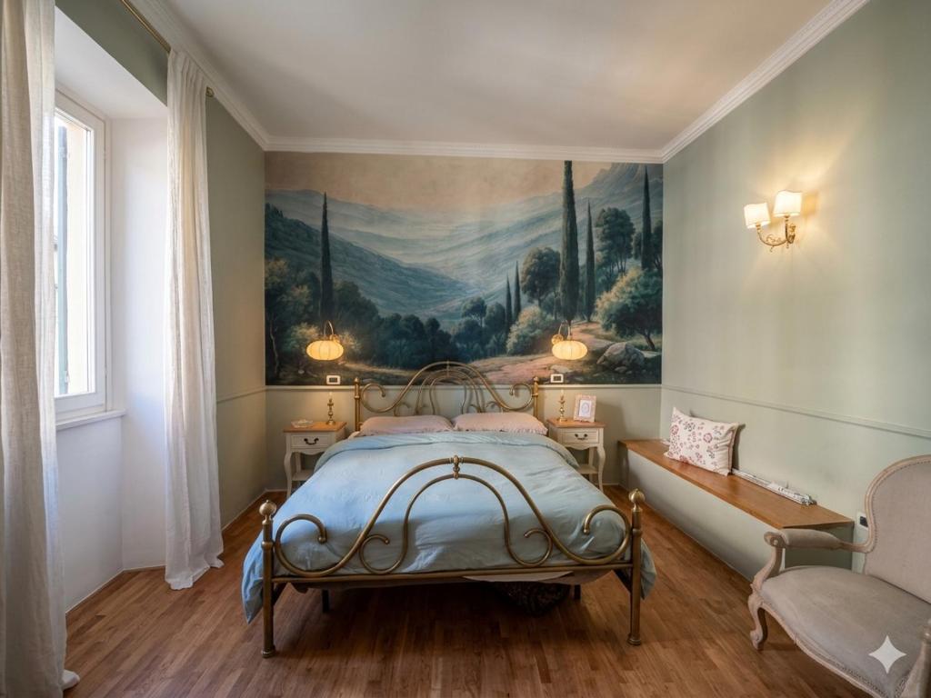 a bedroom with a painting on the wall and a bed at La Specola di Galileo con ampia vasca idromassaggio in Acquasparta