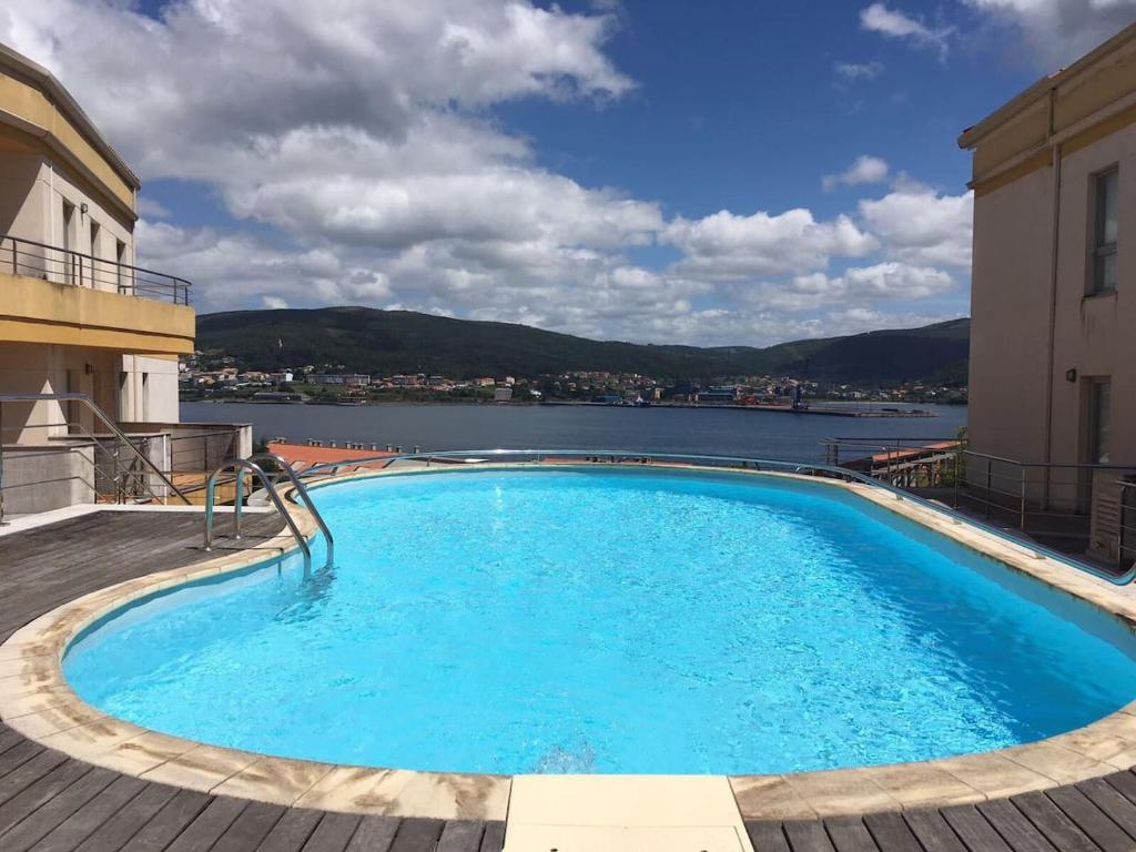 a swimming pool with a view of the water at Apartamento B in Corcubión