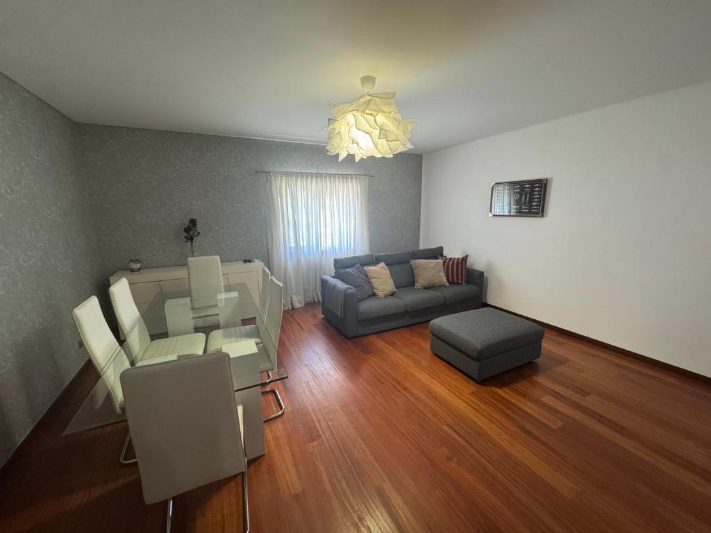 a living room with a couch and a table at Vila Praia House in Vila Praia de Âncora