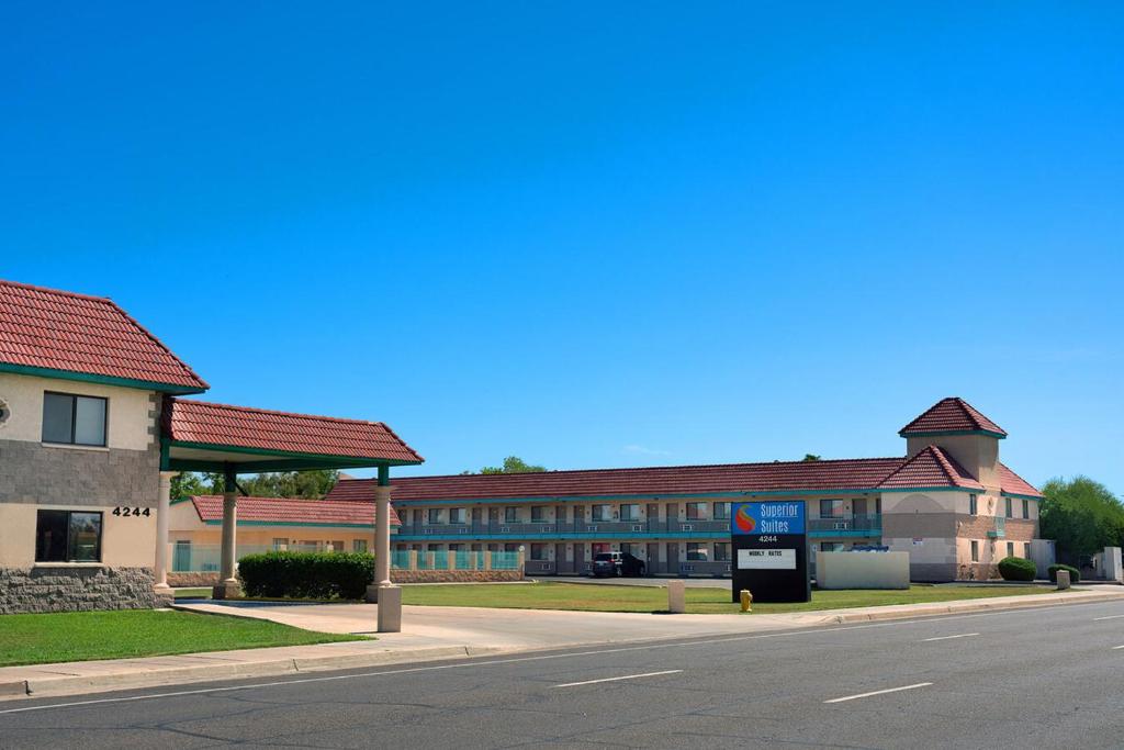 a building on the side of a street with a road at Superior Suites Phoenix Mesa in Mesa