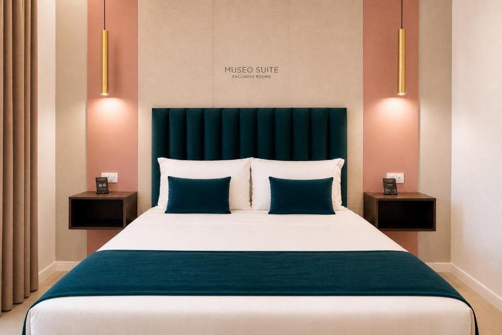 a bedroom with a large bed with blue pillows at Museo Suite in Naples