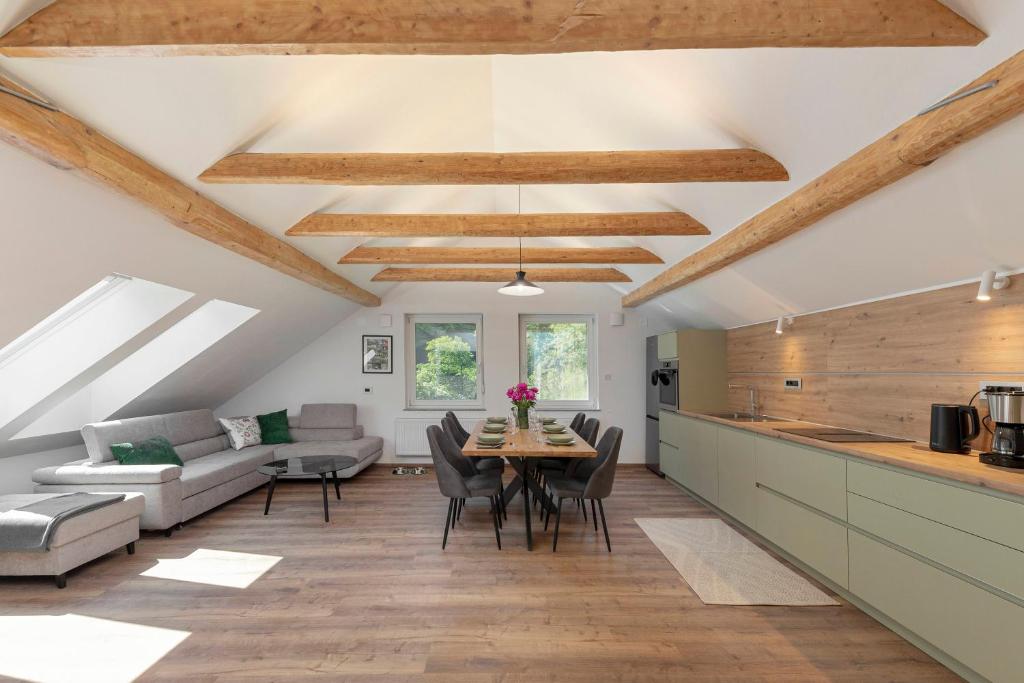 a kitchen and living room with a table and chairs at Brlog in Zgornje Gorje