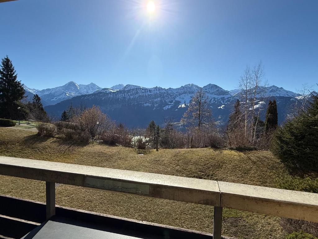 a view of a mountain with the sun in the sky at Blüemlisalp 712 Studio in Beatenberg