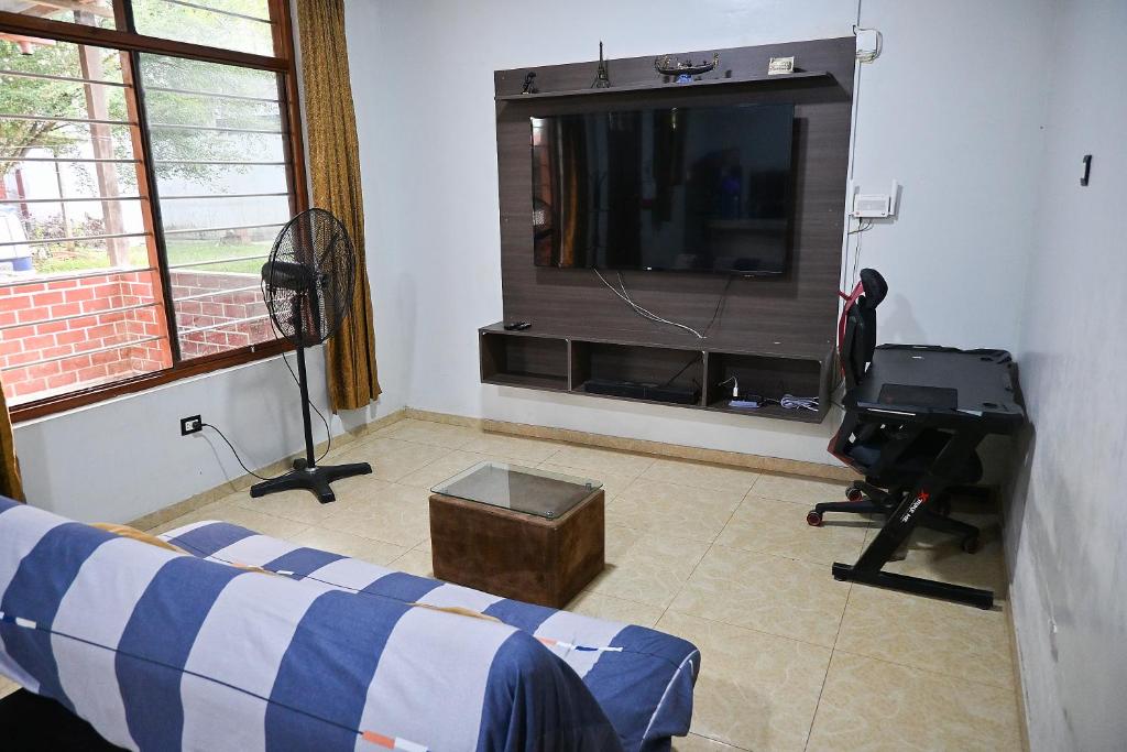 a living room with a large television and a couch at Depa en Pto Maldonado in Puerto Maldonado