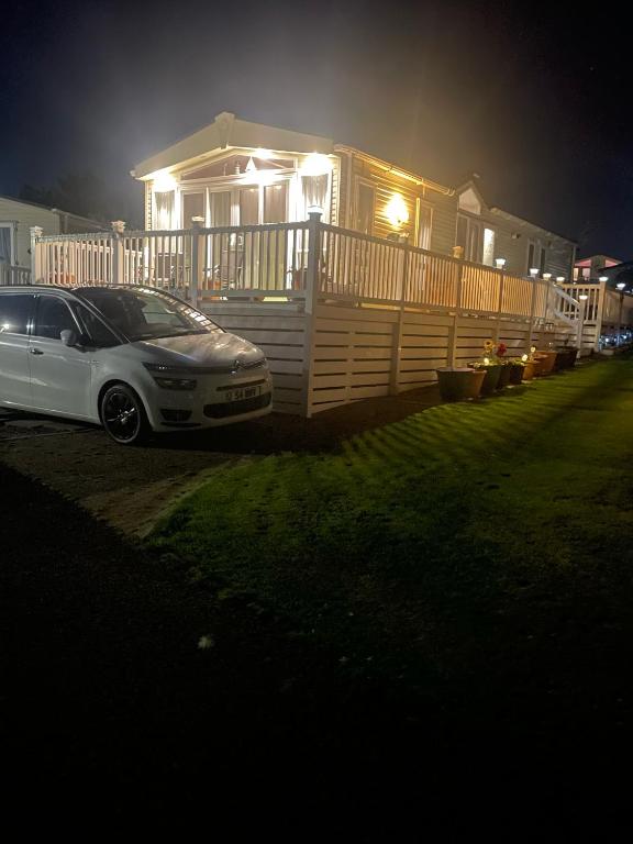a car parked in front of a house at night at Home from Home in Eyemouth