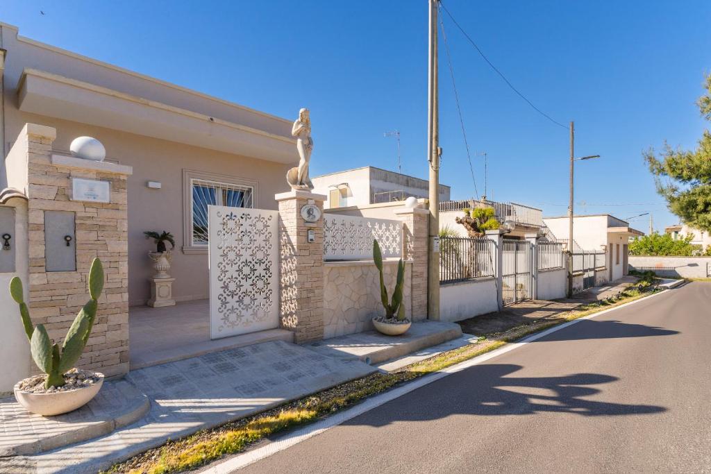 a house with a gate and plants in the street at Domus Afrodite - Torre Squillace in Torre Squillace