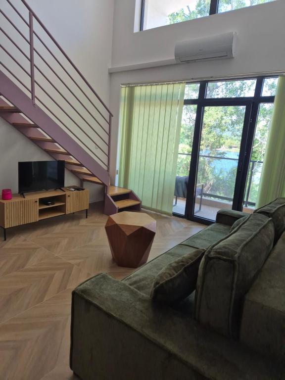 a large living room with a couch and a television at Gonik NN Apartmani in Veliko Gradište