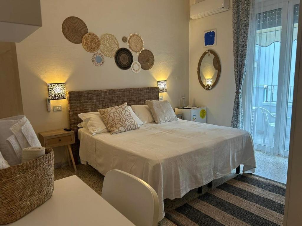 a bedroom with a large bed and a window at Bed and Breakfast Villa Giovanna in Rimini