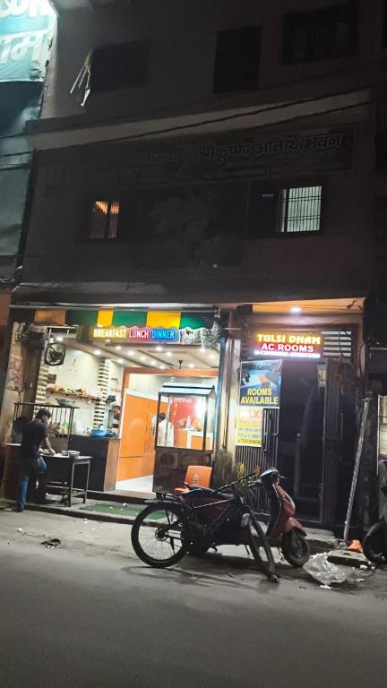 a bike parked on the sidewalk in front of a store at Tulsi Dham in Vrindāvan