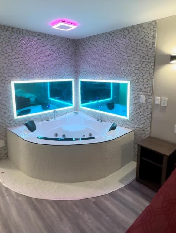 a large bath tub in a room with three windows at Econo Lodge Union City - Atlanta South in Union City