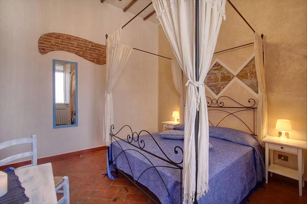 a bedroom with a bed with a canopy at Bronzino Apartment in Florence