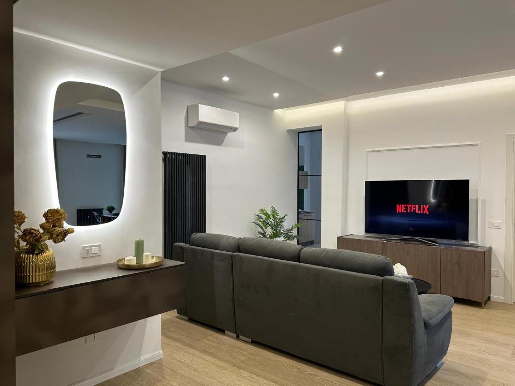 a living room with a couch and a flat screen tv at CR home in Pompei in Pompei