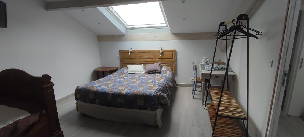 a bedroom with a bed and a skylight at Chambre d'hotes Mas Pékin in Mas-Thibert