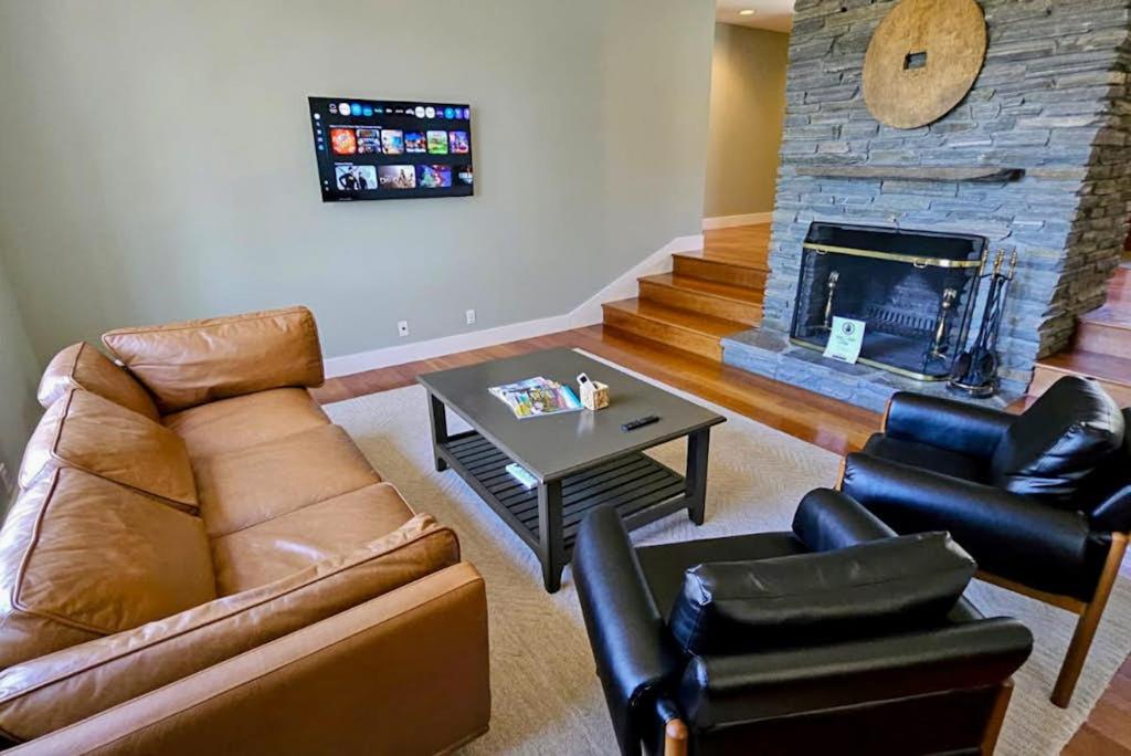a living room with a couch and a fireplace at Partridge Hill House in Hartford