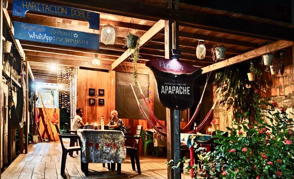 two people sitting at a table in a restaurant at Renacer in Termales - agua caliente - nuqui