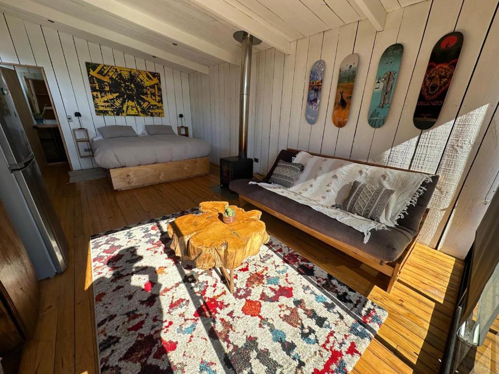 a living room with a couch and a bed at Cabañas La Ola Puertecillo in Navidad