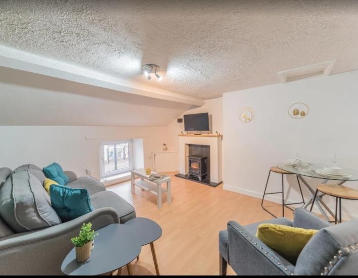 a living room with two couches and a table at Egremont Hide Away - Perfect contractor accommodation - Close to Sellafield in Woodend