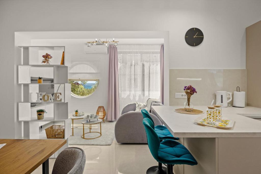 a kitchen and living room with a table and chairs at New luxury apartment RABASOL in Rabac