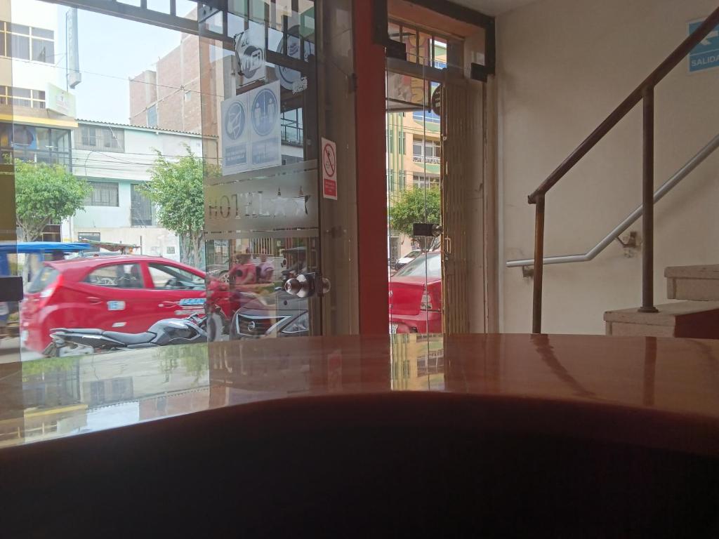 a view of a red car parked outside a building at Hotel Malibu in Chiclayo