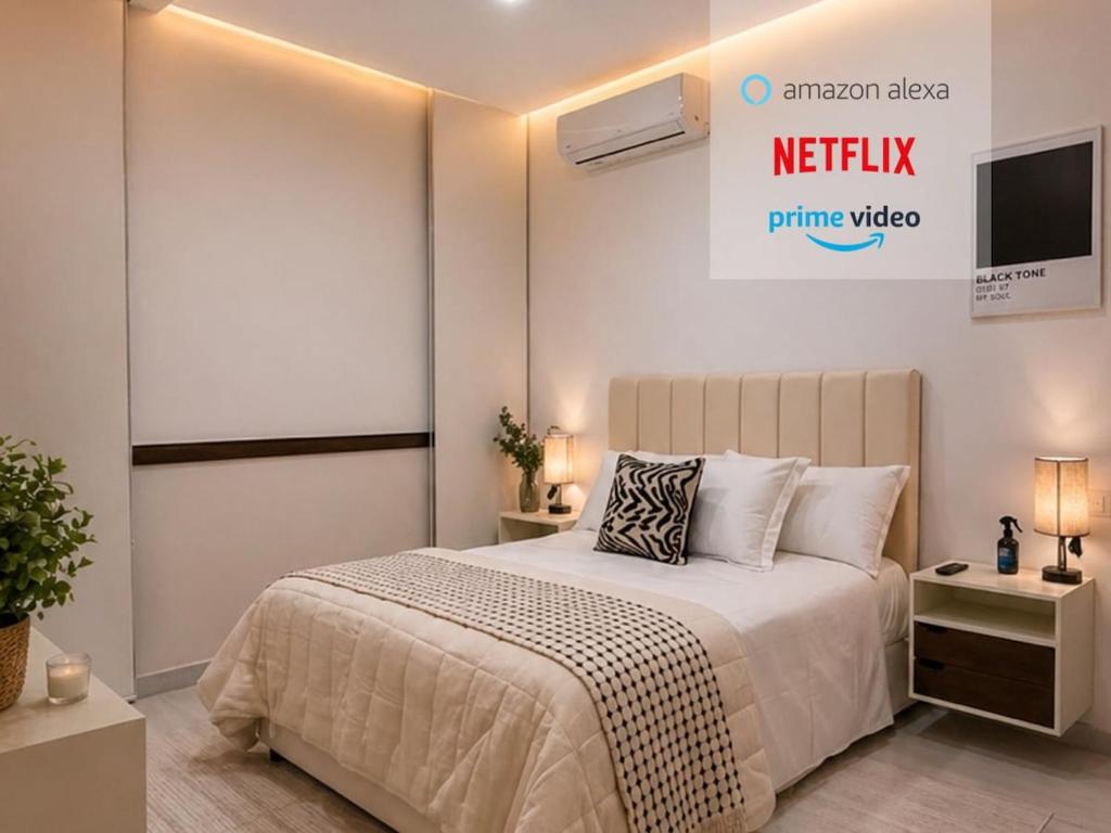 a bedroom with a bed and a tv on the wall at Casa Amelia, 2 habitaciones - PRIME location, visa and passport in Mérida