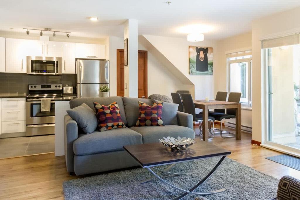 a living room with a couch and a table at 63 Lagoons in Whistler