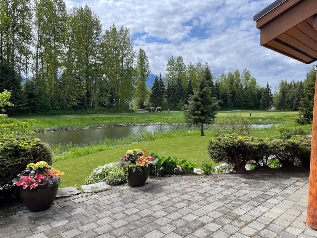 a view of a park with a pond and flowers at 8140 Nicklaus North in Whistler