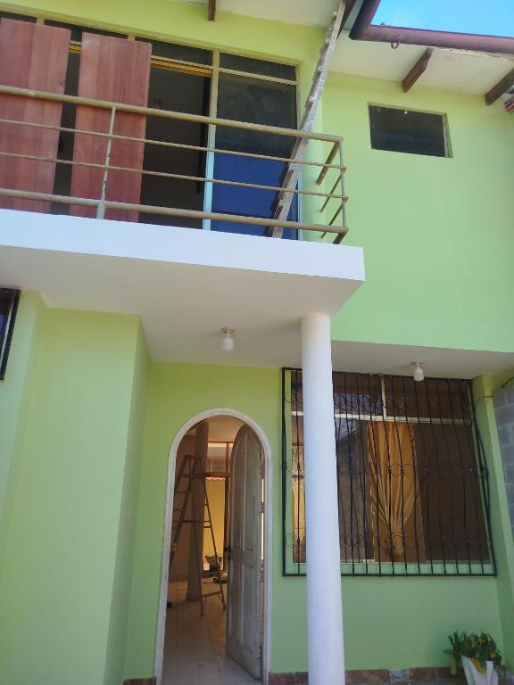a house with a staircase and a balcony at Casa de 2 pisos en Morales in Morales