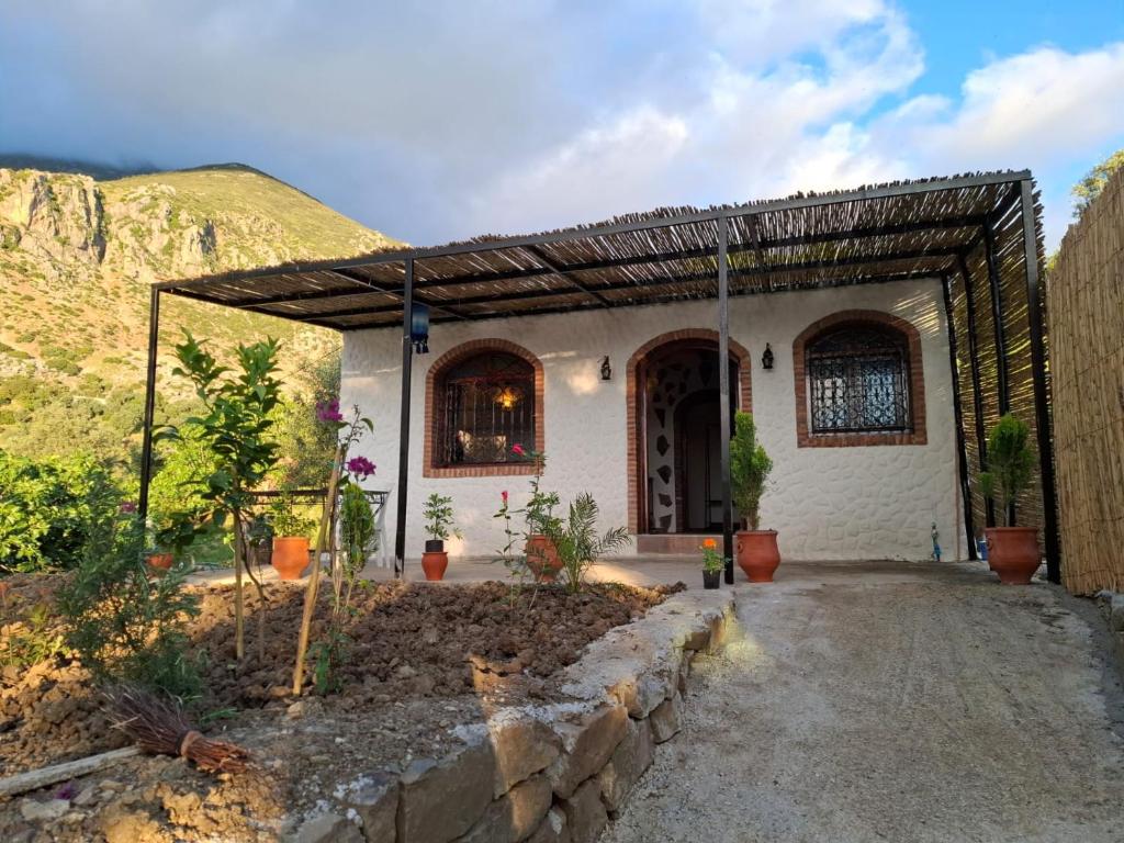 a house with an archway in front of a mountain at blue moon in Chefchaouen