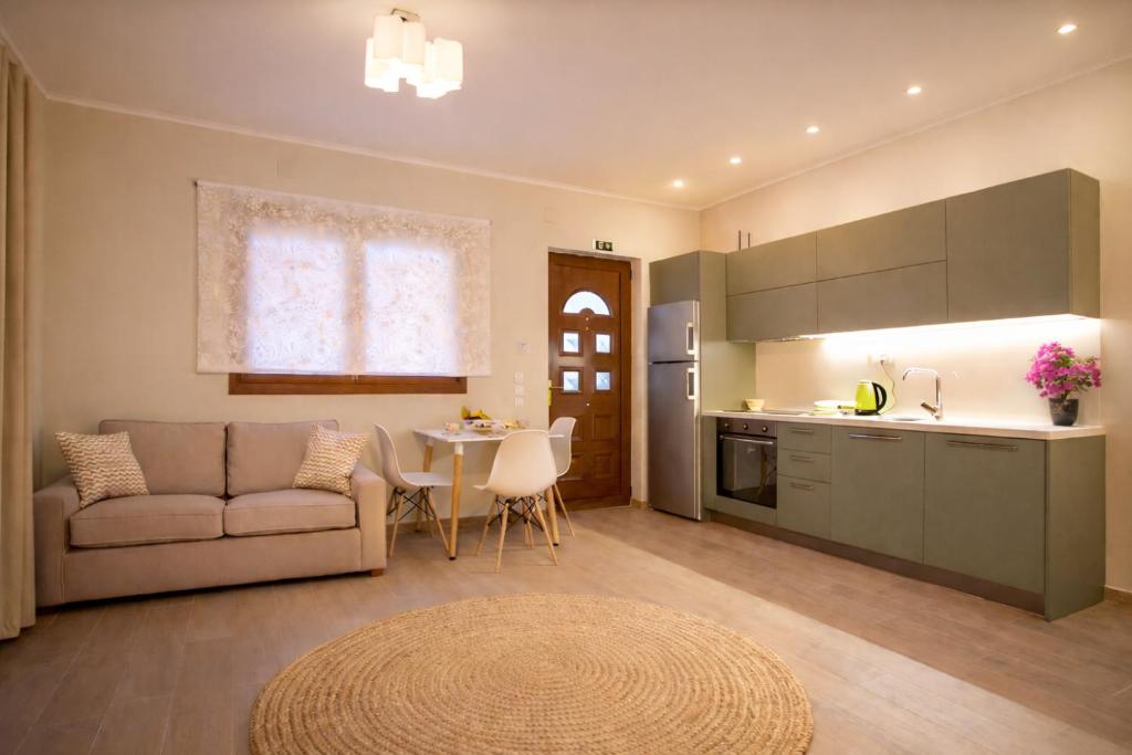 a kitchen and living room with a couch and a table at Nikoletta 4 in Vlachopoulátika