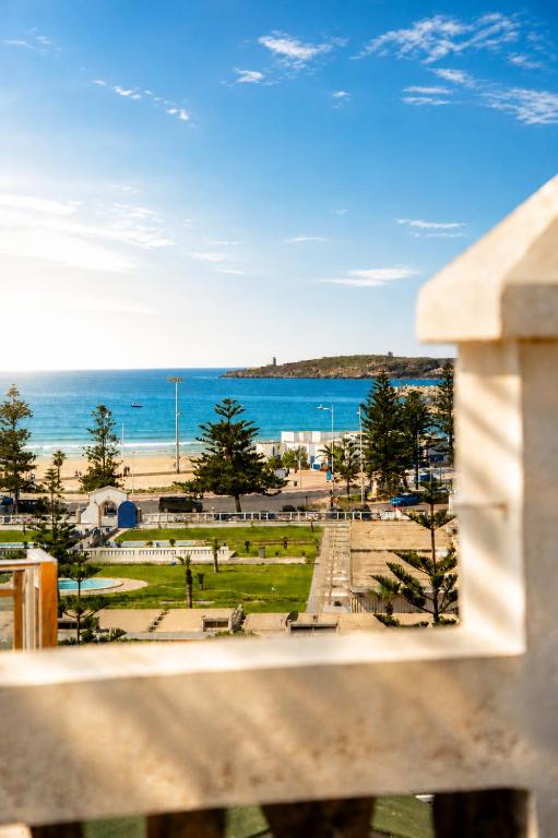 a view of a park with the ocean in the background at Riad Chama in Essaouira