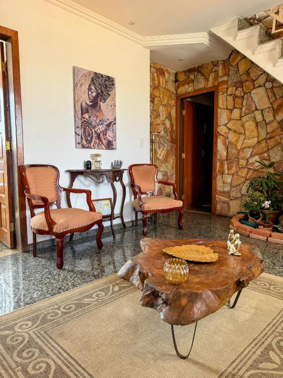 a living room with a table and chairs at Suite casal 2 com frigobar in Belo Horizonte