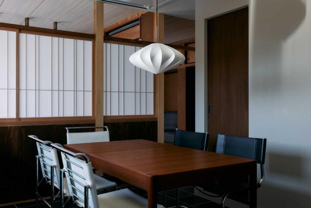 a dining room with a wooden table and chairs at 一組限定の宿 季の間 Private Traditional House & Tea Experience in Nagano in Iida