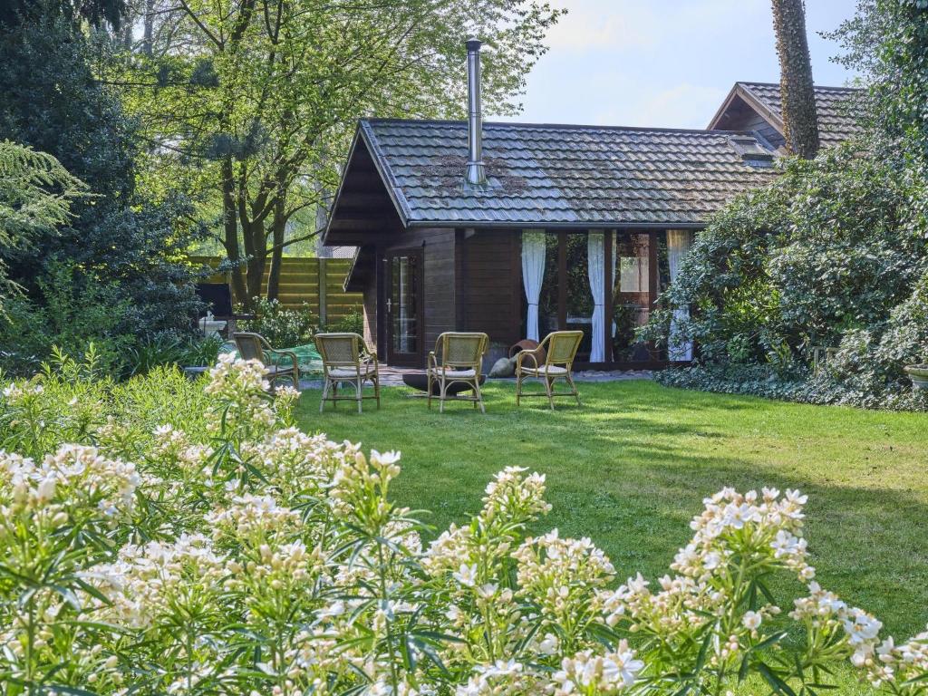 a house with chairs in the yard of a garden at Zee van tijd in Kasterlee