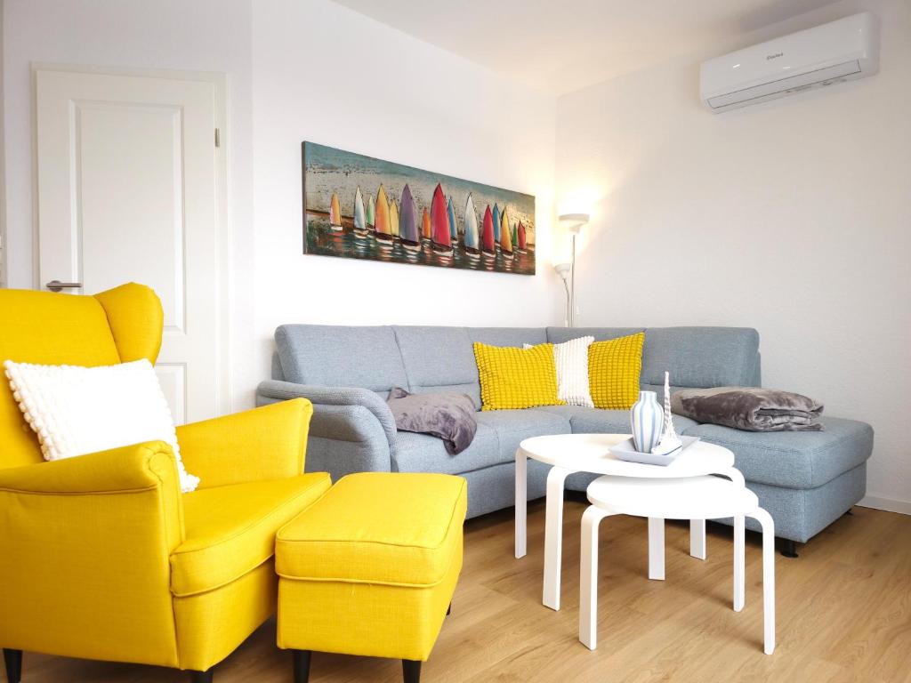 a living room with a couch and a table at Ferienhaus Margarete in Dornumersiel