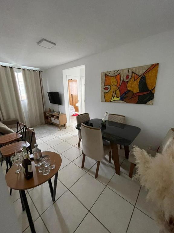 a living room with a table and a piano at Excellent value for money - Fully equipped apartment in Macaé