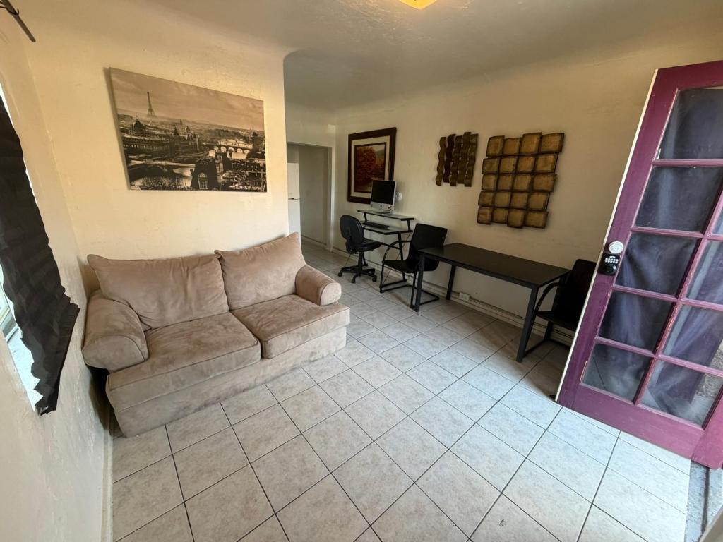 a living room with a couch and a table at Downtown Purple Apartment in Phoenix