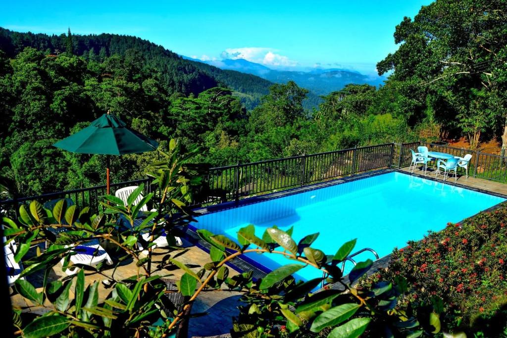 a swimming pool with a view of the mountains at Grand Hills in Kandy