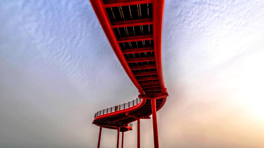 a red spiral staircase in the sky at Currently Occupied in Alfragide