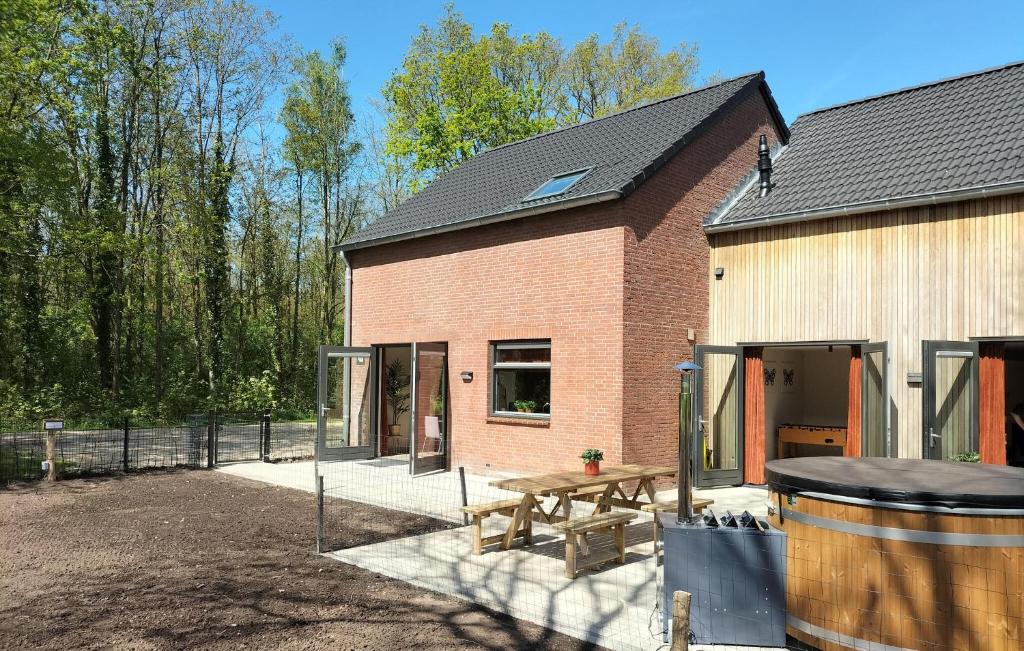 a building with a picnic table and a barrel at 5 Bedroom Luxurious Home In Afferden in Afferden