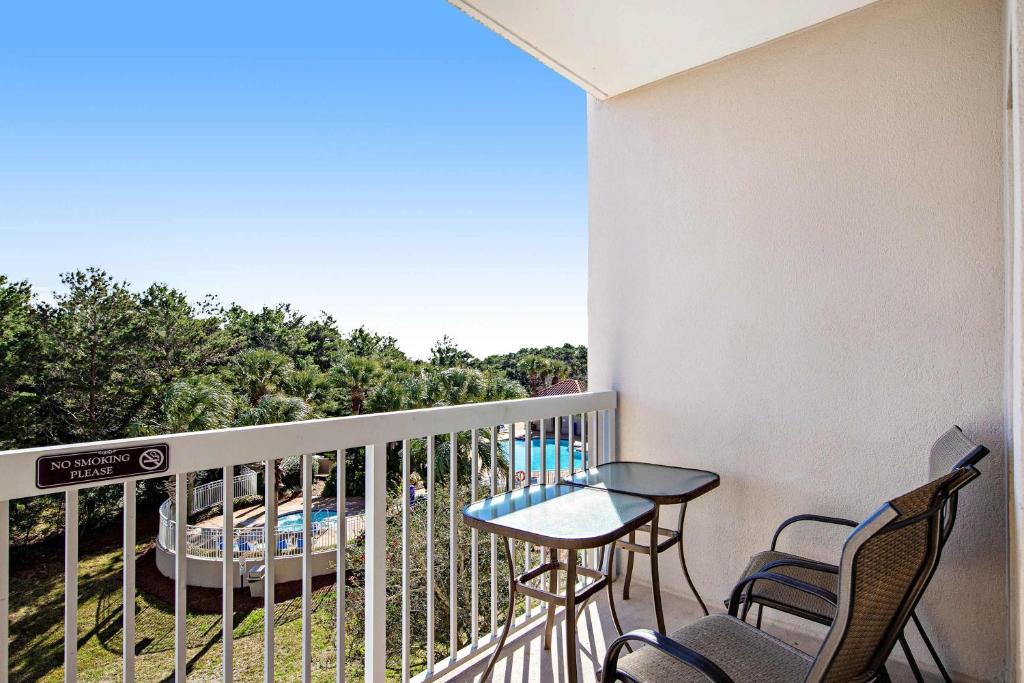 a balcony with a table and chairs and a pool at Beachside Resort Condo with Pools and Tennis in Destin