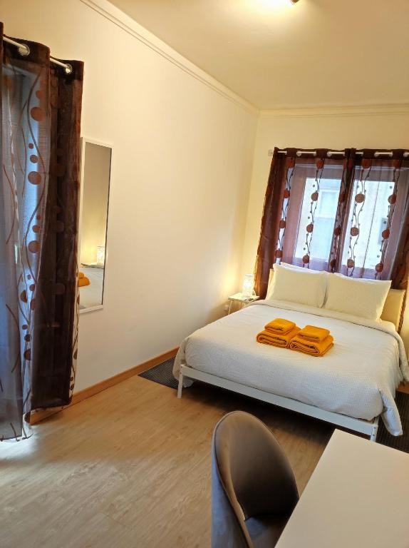a bedroom with a white bed and a window at Vista Central Amadora in Amadora
