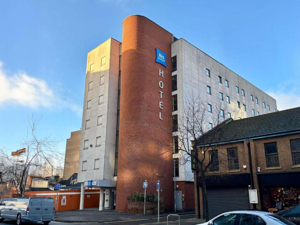 a tall building with a sign on the side of it at ibis budget Belfast City Centre in Belfast