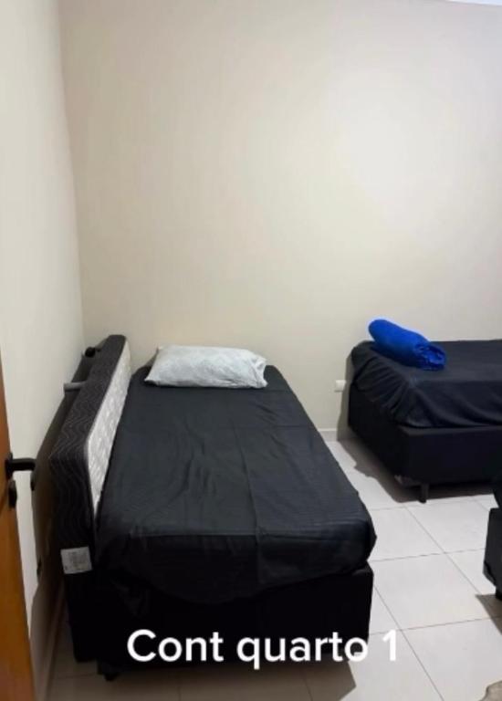 a room with two beds in a room at Ice pool house in São Vicente