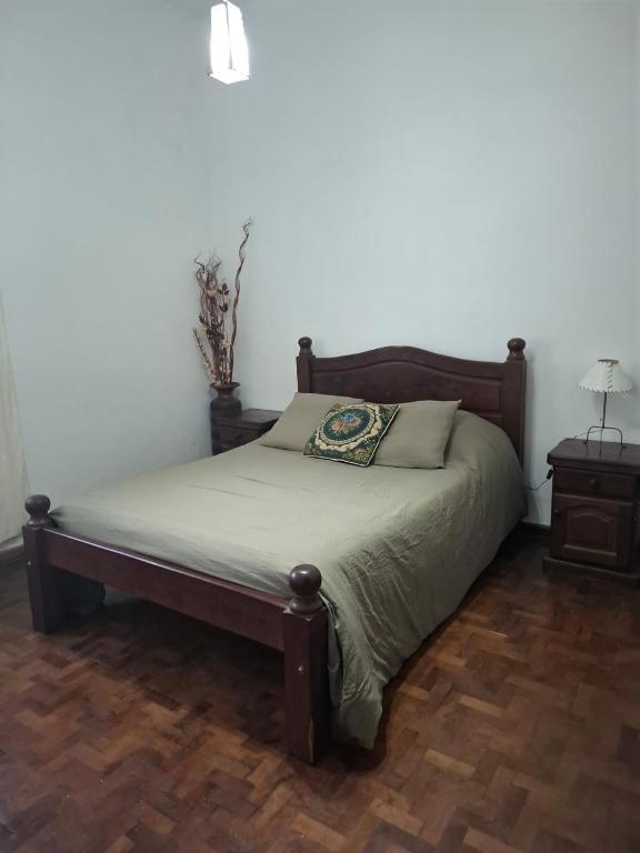a bed in a room with a bed sidx sidx sidx at De Paso Pergamino in Pergamino
