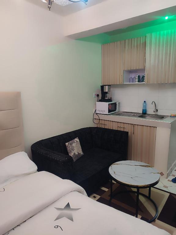 a living room with a couch and a table at Harmony Haven in Rungiri