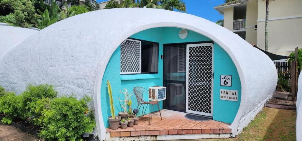 a small house with an archway in a yard at Binishell Igloo 6 - Famous Beachfront Dome with Pool in Trinity Beach