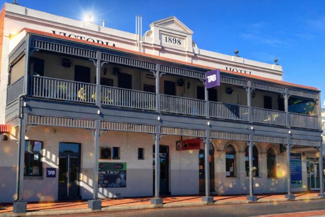 a building on the corner of a street at The Victoria Hotel in Collie