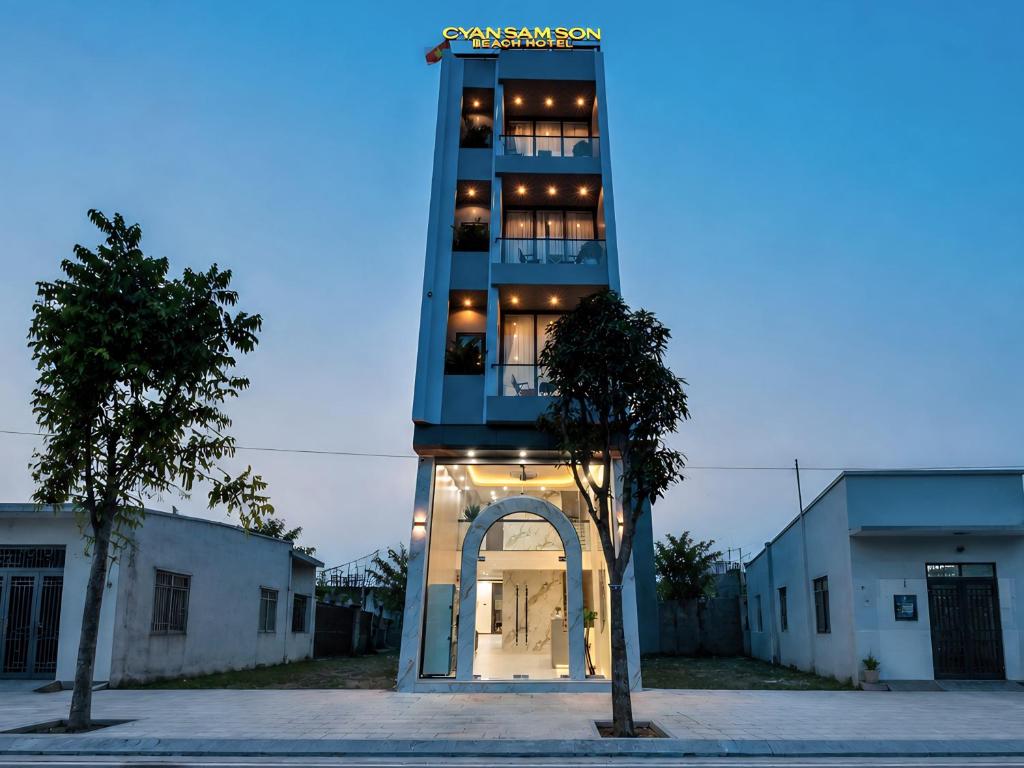 a tall building with an arch in front of it at Cyan Sầm Sơn Hotel in Sầm Sơn